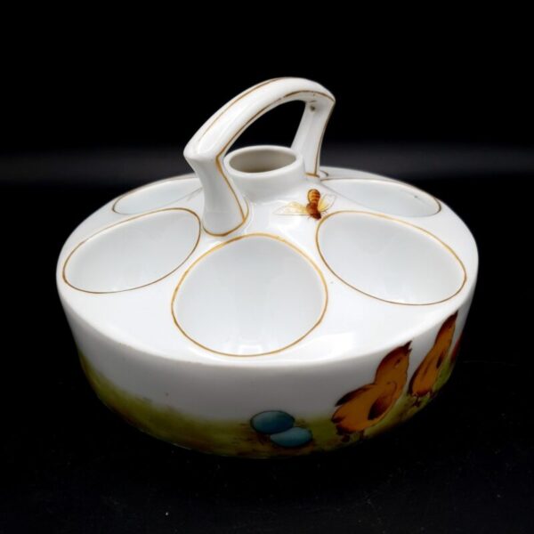 Antique Victorian ceramic heated egg cruet for six eggs decorated with chicks, colourful eggs, a bee and grass