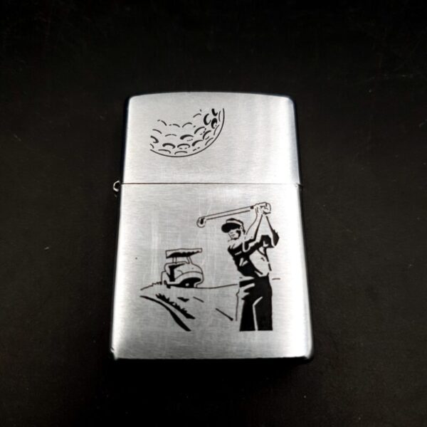 1999 Zippo brushed chrome lighter with etched golf design and original box