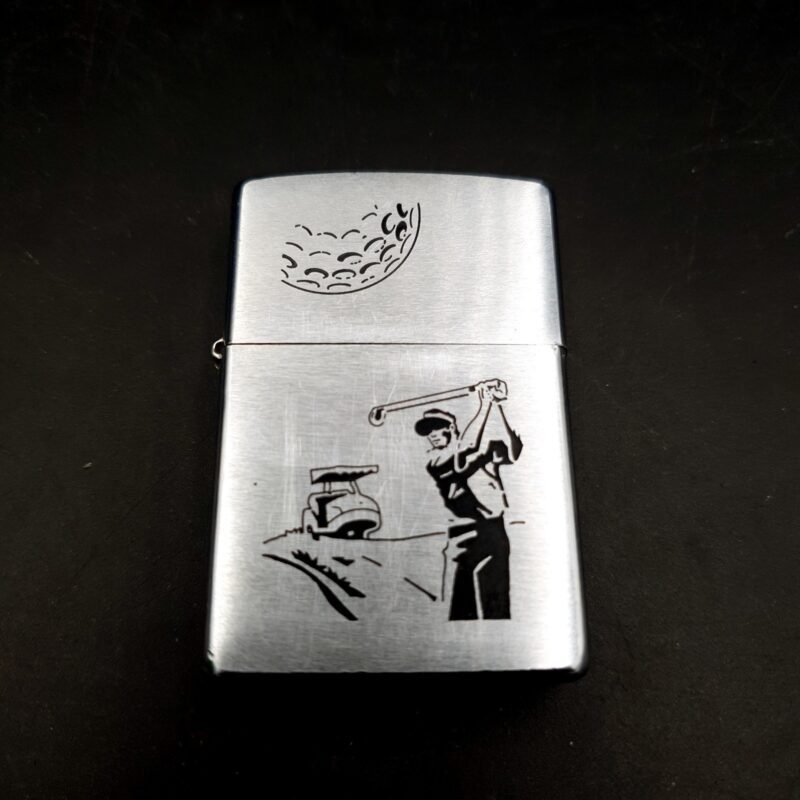 1999 Zippo brushed chrome lighter with etched golf design and original box