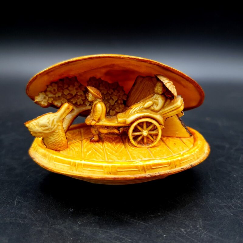 Vintage Japanese celluloid clam shell diorama with miniature rickshaw scene and dragon design