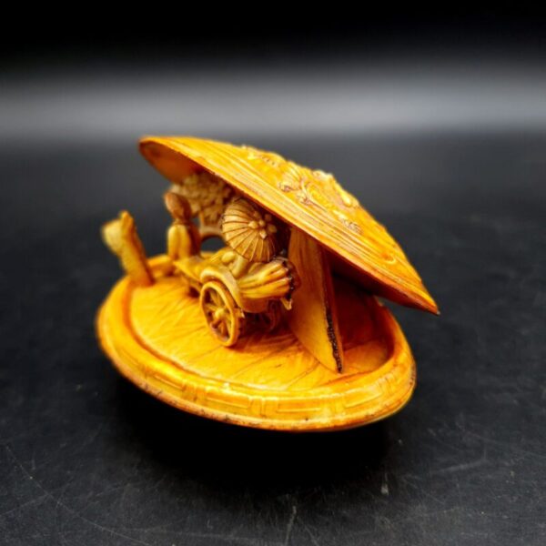 Vintage Japanese celluloid clam shell diorama with miniature rickshaw scene and dragon design