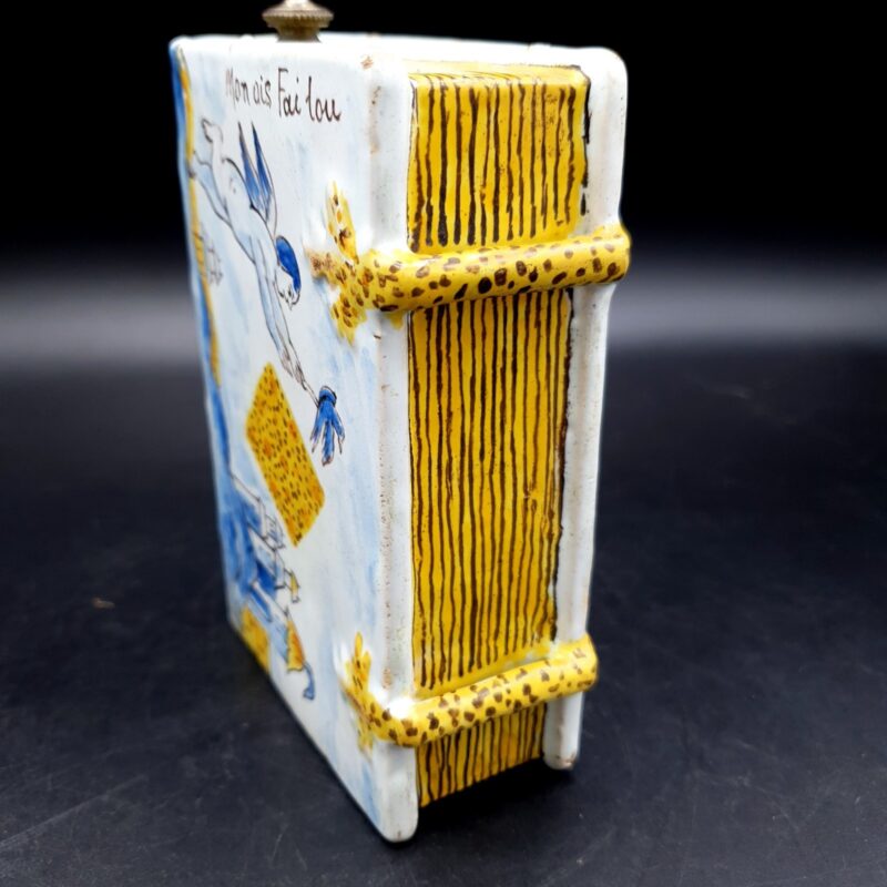 Antique faience secouette showing painted French inscription and decorative scene