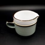 Vintage Denby Romance stoneware milk jug with floral decoration and green border