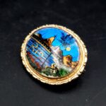 Oval Brazilian butterfly wing brooch with blue iridescent background