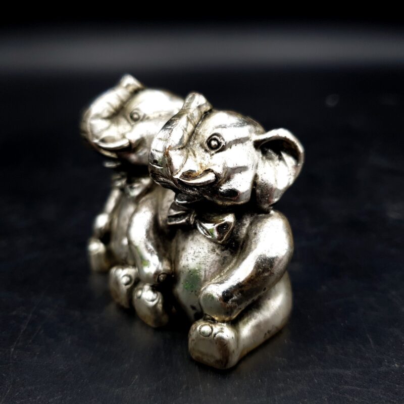Two seated R. Argento elephant figures with raised trunks