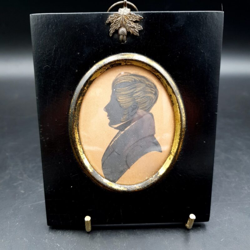 Antique 19th-century ink profile portrait of a gentleman in apparent Regency-style dress with ebonised wood surround