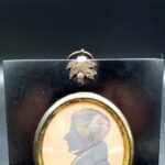Antique 19th-century ink profile portrait of a gentleman in apparent Regency-style dress with ebonised wood surround