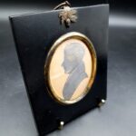 Antique 19th-century ink profile portrait of a gentleman in apparent Regency-style dress with ebonised wood surround
