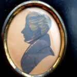 Antique 19th-century ink profile portrait of a gentleman in apparent Regency-style dress with ebonised wood surround