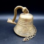 Vintage Brass Pull Bell with chain and wall attachment Bell is 9cm tall 690g