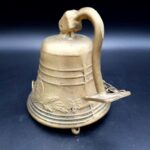 Vintage Brass Pull Bell with chain and wall attachment Bell is 9cm tall 690g