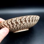 Close-up of textured geometric surface on Terra pottery bowl