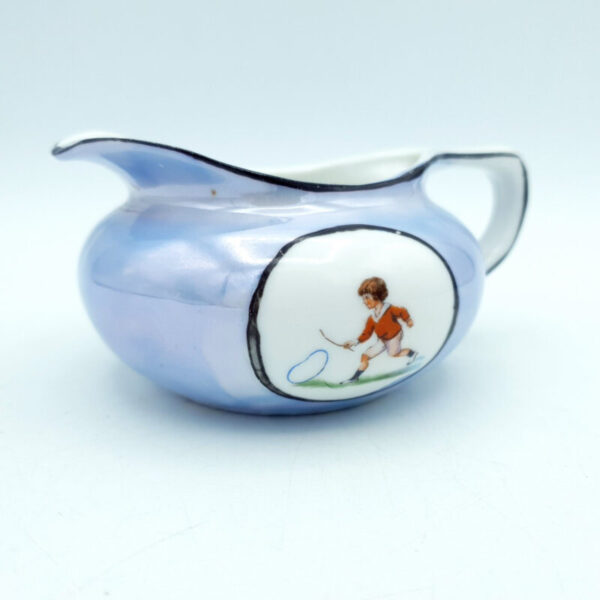 Antique British lustreware cream jug with iridescent blue and pink glaze and child playing with hoop decoration